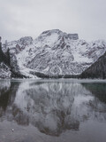 Lago di Braies completly frozen during the winter season with a beautiful water reflection