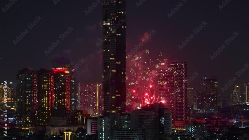 View of fireworks fireworks sparks explosions in the sky among tall buildings skyscrapers night city View of fireworks fireworks sparks explosions in the sky among tall buildings skyscrapers night city