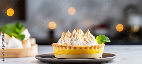 Delicious lemon meringue pie and assorted lemon desserts in a kitchen with blurred background photo