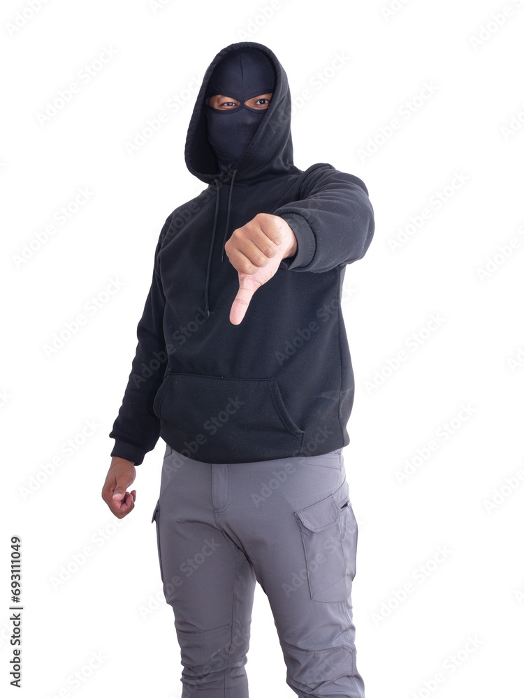 An unidentified male criminal wearing a black hoodie and covering his face stands with a thumbs up. On a white background with cliping path. Thief.weapon, crime.