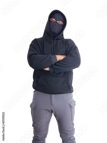 An unidentified male criminal wearing a black hoodie and covering his face stands with his arms crossed on his chest. On a white background with cliping path. Thief.weapon, crime.