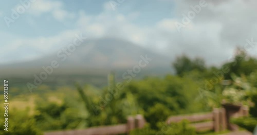 Woman enjoy view on Legazpi Mountains Volcano, Philippines. Asia wild nature tropical landscape. Tourist female relax, outdoor lifestyle travel on summer holiday vacation. Back view, slow motion photo