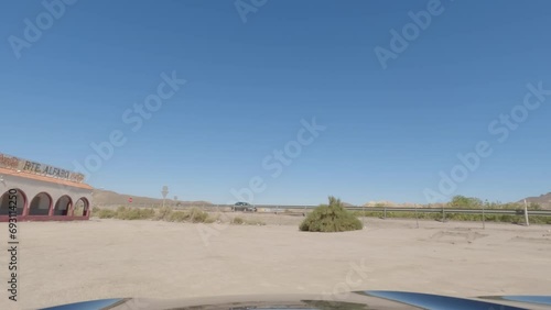 First person view, FPV, from dashcam of car driving towards abandoned diner in Tabernas desert, Almeria, Andalusia, Spain, Europe. Road trip video in POV in arid, dry climate photo