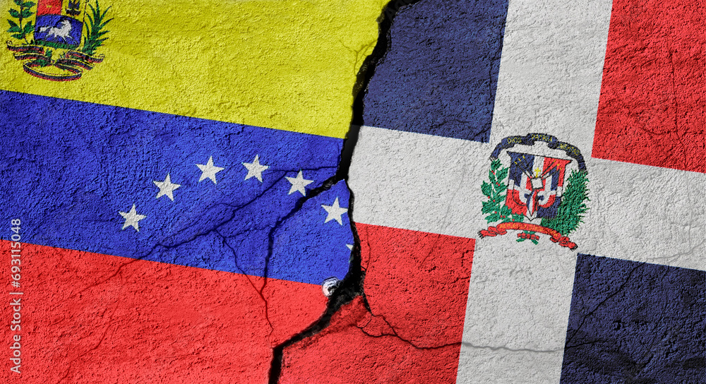 Fototapeta premium Venezuela and Dominican Republic flags on a stone wall with a crack, illustration of the concept of a global crisis in political and economic relations