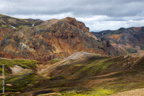 The picturesque Icelandic landscape of rainbow volcanic rhyolite mountains in cloudy weather on Icelandic highlands at Landmannalaugar, Iceland. Famous Laugavegur hiking trail. Iceland in august. 