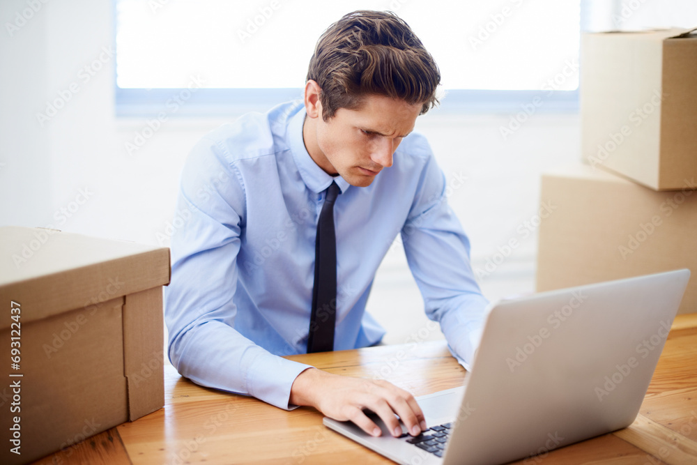 Business man, moving boxes and stress by laptop, entrepreneur and online logistics for courier. Male person, professional and late delivery for company distribution, frustration and shipment or fail Business man, moving boxes and stress by laptop, entrepreneur and online logistics for courier. Male person, professional and late delivery for company distribution, frustration and shipment or fail