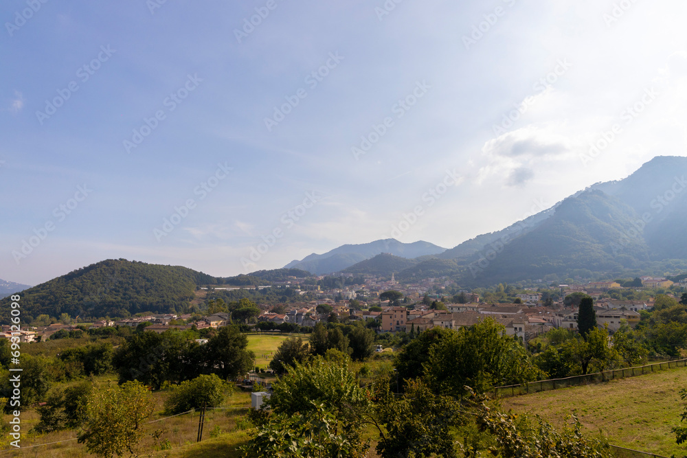 Campania region panoramic Irno valley in the province of Salerno, landscape of a small village with bell tower in the center under the hills
