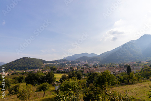 Campania region panoramic Irno valley in the province of Salerno, landscape of a small village with bell tower in the center under the hills photo