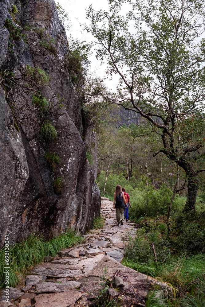 tourists on a footpath climb to the mountains tourists on a footpath climb to the mountains