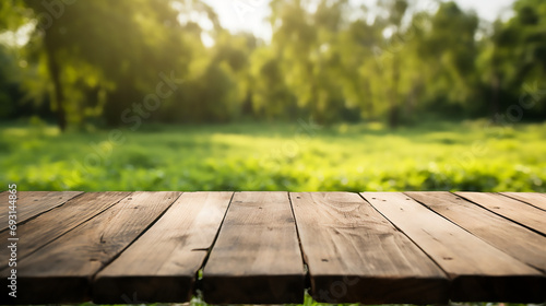 Fototapeta Naklejka Na Ścianę i Meble -  Empty old wooden table with green nature background, Template, Mock up 