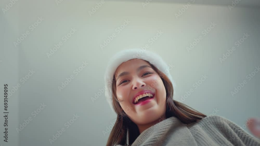 Happy excited young asian woman wearing a Santa hat unbox parcel, Surprise female looking inside Christmas gift with smile, joy, amazement, opening package, Christmas and new year. Happy excited young asian woman wearing a Santa hat unbox parcel, Surprise female looking inside Christmas gift with smile, joy, amazement, opening package, Christmas and new year.