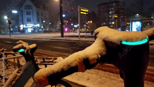 Snowy winter night with escooter or emobility bike sharing concepts in snowy city streets shows environmental friendly mode of transportation in snowfall as electric vehicle in modern city life safety photo