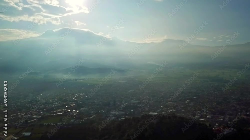 HD aerial video of the Magical town of Amecameca, State of Mexico, passing through the center of the town and in the background the Iztacihuatl Volcano at dawn. HD aerial video of the Magical town of Amecameca, State of Mexico, passing through the center of the town and in the background the Iztacihuatl Volcano at dawn.