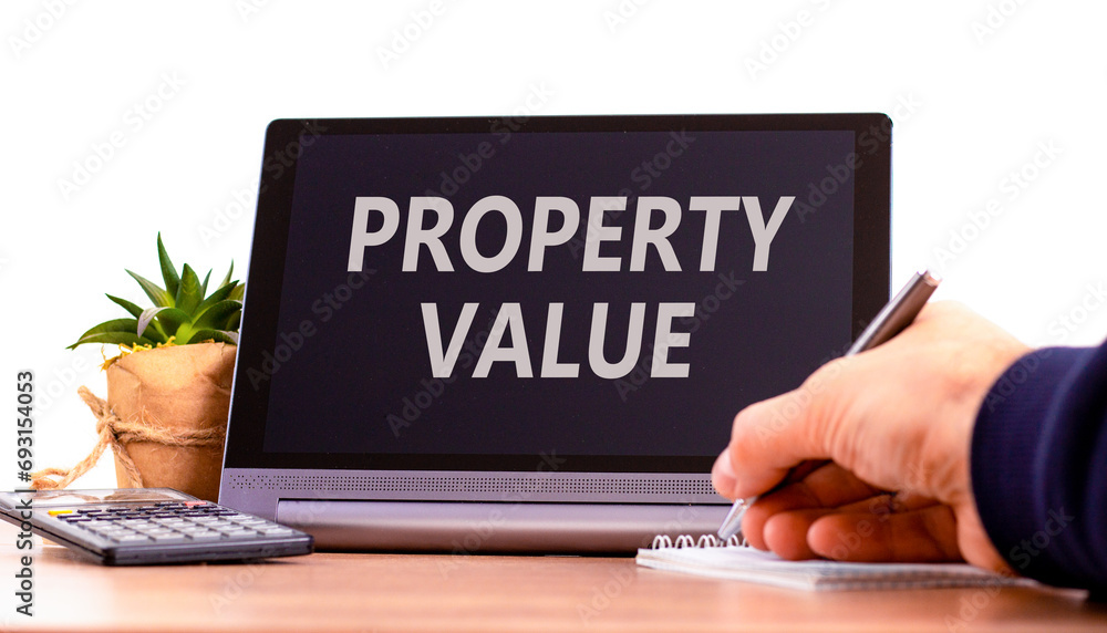 Property value symbol. Concept words Property value on beautiful black tablet. Beautiful white background. Calculator. Businessman hand. Business property value concept. Copy space. Property value symbol. Concept words Property value on beautiful black tablet. Beautiful white background. Calculator. Businessman hand. Business property value concept. Copy space.