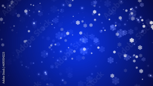   Snowflakes falling on blue background  Winter Christmas Holiday.  