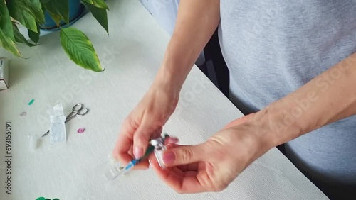 Close up footage of the woman with beautiful hands, preparing hormone medicine and injecting herself to the abdomen with pierced bellybutton. Family planning