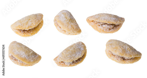 Set of sweets with yummy nut filling in shell shape isolated on a white background. Closeup of delicious Christmas or wedding walnut cookies powdered with vanilla sugar from traditional Czech cuisine. photo