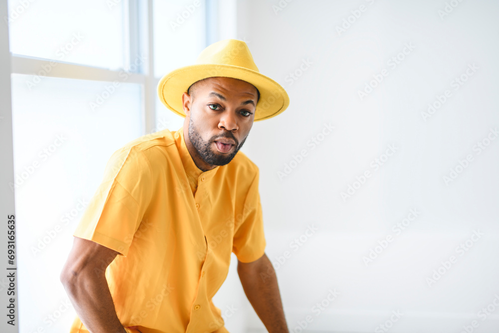 young adult american man standing at home background with fashion clothes