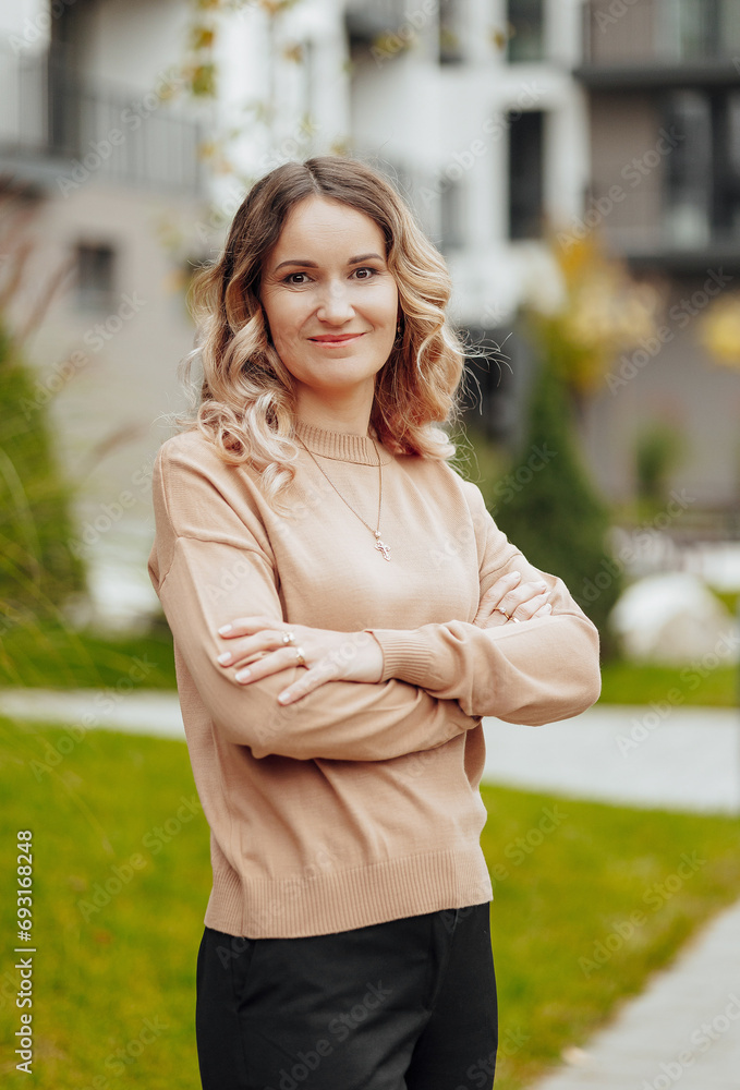 Vertical photo. Beautiful carefree young teenage girl in casual clothes. Portrait of a beautiful girl against the background of nature with a blurred background. Vertical photo. Beautiful carefree young teenage girl in casual clothes. Portrait of a beautiful girl against the background of nature with a blurred background.
