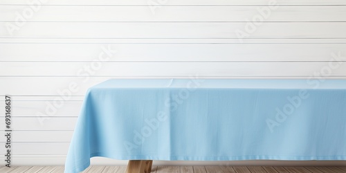 Mock up design featuring a blue tablecloth on a white wooden table with copy space. photo