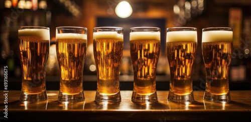 a row of beer glasses lined up in a bar photo