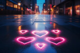 Defocused glowing pink heart shaped neon lights on an dark blue asphalt road at night.