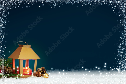 Christmas sparkling lantern on white snow and blue background.