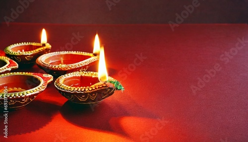 happy diwali clay diya lamps lit during diwali hindu festival of lights celebration colorful traditional oil lamp diya on red background