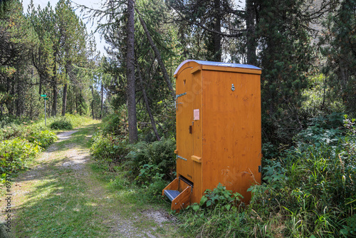 Mobile compost toilet at a hiking roadside. The eco friendly toilet uses sawdust to cover human excrement for cycling. photo