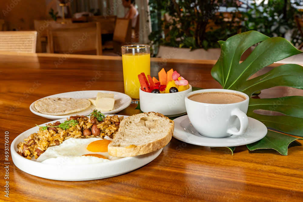 Colombian breakfast with arepas, coffee, bread, eggs, warmed rice and fruit Colombian breakfast with arepas, coffee, bread, eggs, warmed rice and fruit