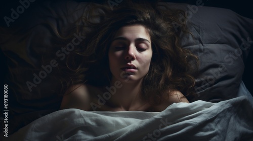 a young woman with insomnia in the bed