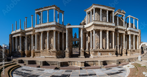 Panoramic view of the ancient Roman theater ruins of Merida, Spain under clear blue sky. photo