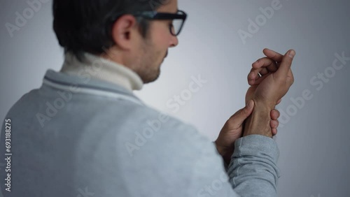 Man massaging his sore wrist photo