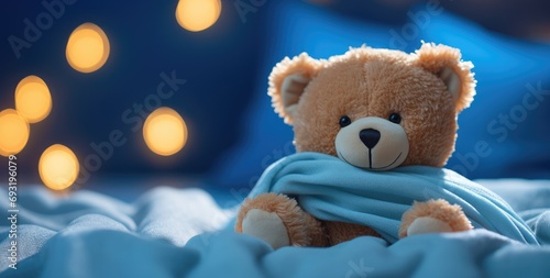 a bear is sitting on a blue blanket