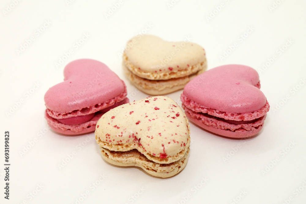 Group of heart shaped macaroons on white background close-up. Group of heart shaped macaroons on white background close-up.