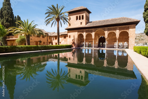 Beautyfull The portico in El Palacio del Partal  or Partal Palace reflected in goldfish pool. Albaicin old town, Alhambra castle, Andalusia, Spain. photo