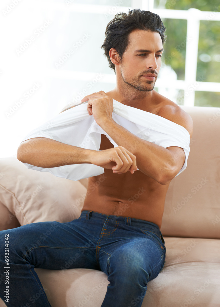 Take off, tshirt and man on sofa in a house for comfort, rest or chilling on weekend, day off or vacation. Sweater, removal or male person in living room undressing, relax and ready to be comfortable Take off, tshirt and man on sofa in a house for comfort, rest or chilling on weekend, day off or vacation. Sweater, removal or male person in living room undressing, relax and ready to be comfortable