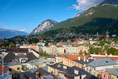 Innsbruck Colorful Buildings and Alps. The view from old town Innsbruck with colorful buildings on the Inn River. The Nordkette Alps rise in the background. Tyrol, Austria