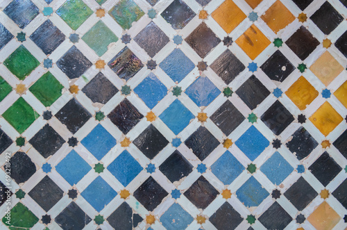 colored mosaic tiles on the wall of the Alhambra palace in Granada, Andalucia, Spain photo