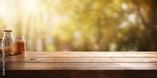 Blurred kitchen window in background of empty wooden table.