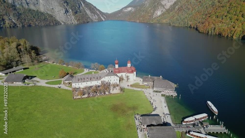 The drone aerial footage of Lake Konigsee with Sankt Bartholomae pilgrimage church, Berchtesgadener land, Bavaria, Germany. photo