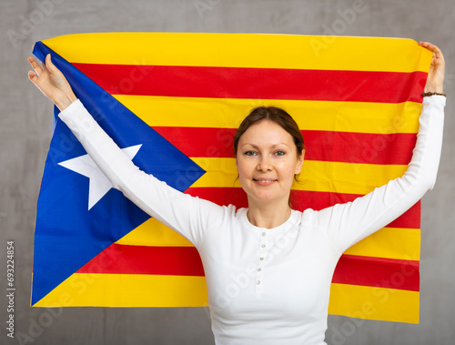 Excited positive young girl with Catalonia flag rooting for your favorite team