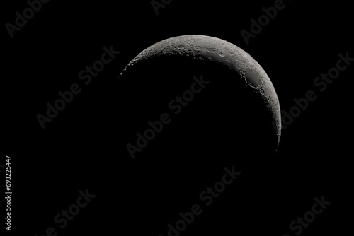 Obraz na płótnie Crescent moon photographed with a telescope, where you can see the craters and the lunar surface, it will soon be a moon landing site w salonie