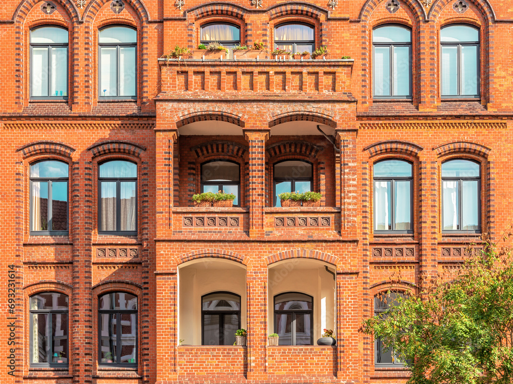 Facade of typical residential red bricks building with arched windows. Apartment house in Hannover, Germany	

