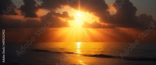 Imagine a mystical sunset over a vast sea, with golden rays of light peeking through the clouds and casting a warm glow over the water.