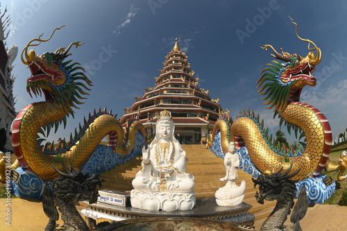 The staircase with dragon and Guan Yin Bodhisattva Statue to Phop Chok ThamaChedi Phra Maha Chedi aT Wat Huay Pla Kang temple in Chaing Rai Province in Thailand.