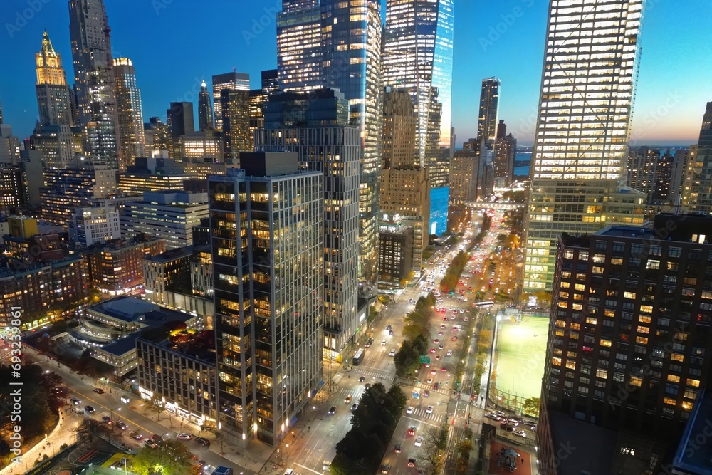 Fototapeta premium Night New York City, Manhattan famous top view. Night Manhattan from above. Manhattan panorama at sunset. NYC skyline at twilight. New York famous building. Night traffic in NYC. Lower Manhattan.