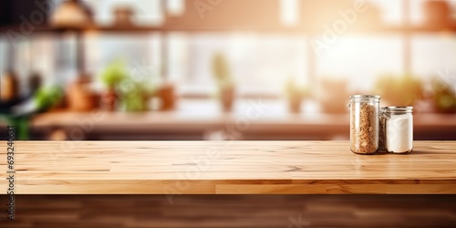 Wooden table top view with blurred kitchen interior background for product montage.