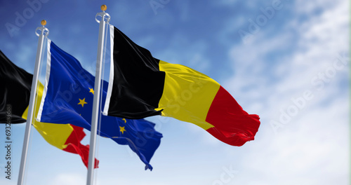 Belgium national flags and the European union flags waving in the wind photo