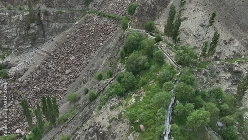 Skardu's Mantoka Waterfall in Rugged Terrain, Pakistan. Aerial flyover photo